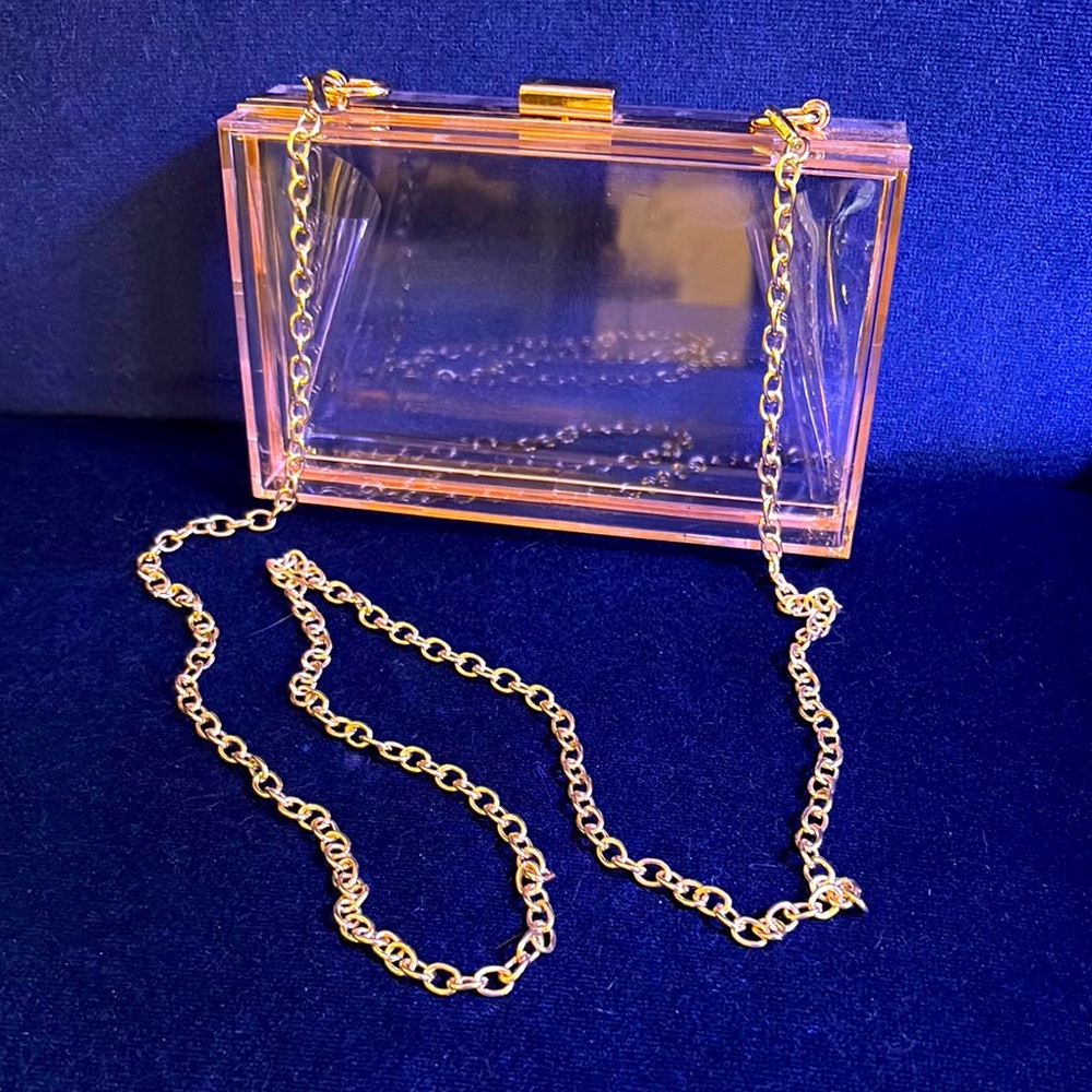 Clear acrylic stadium purse with gold trim and chain strap